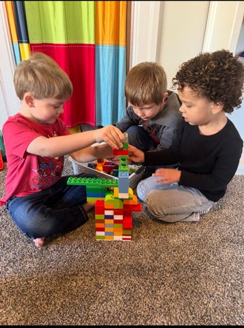 three little boys playing legos