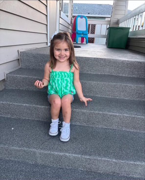little girl sitting on steps